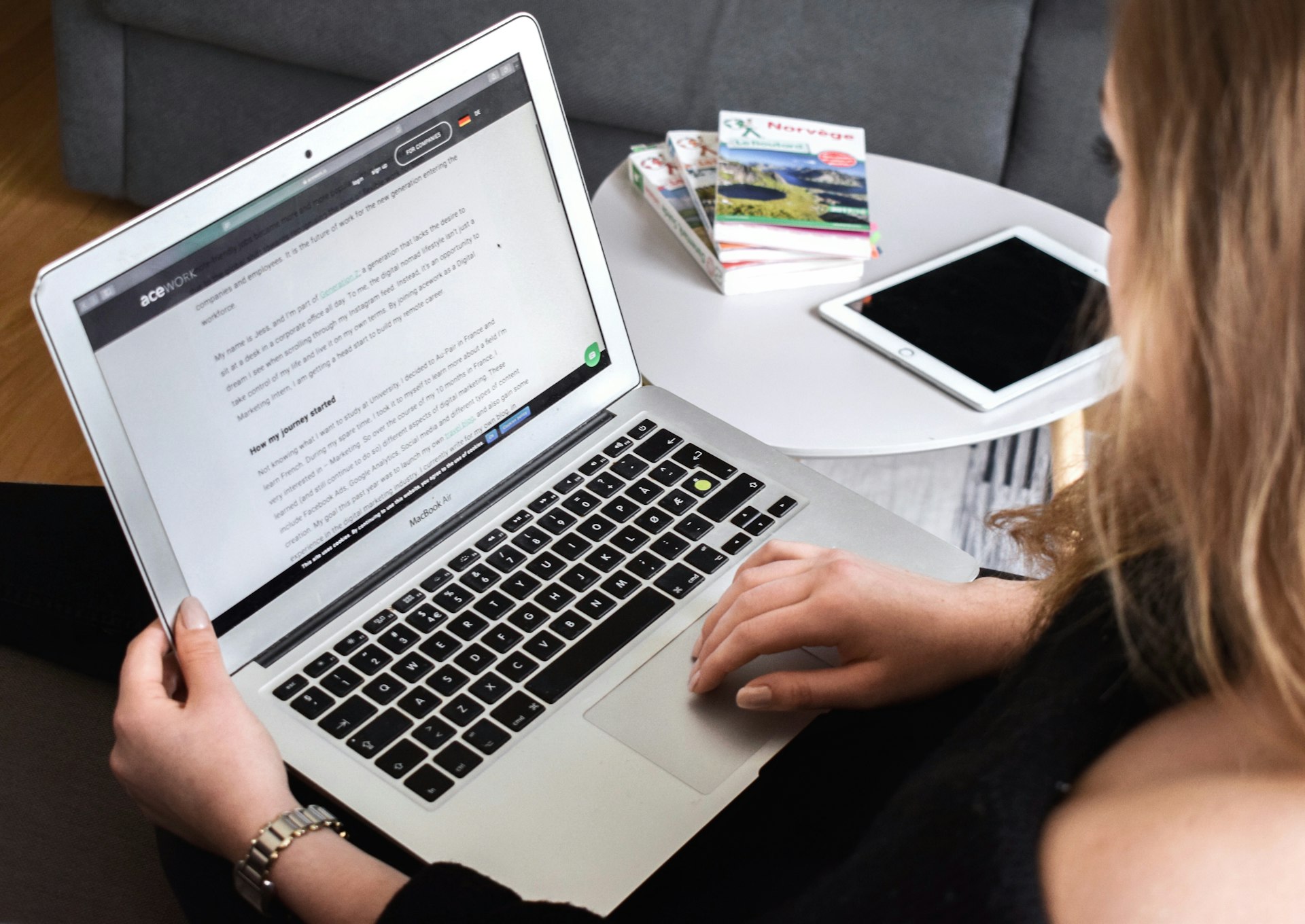 person using macbook air on lap